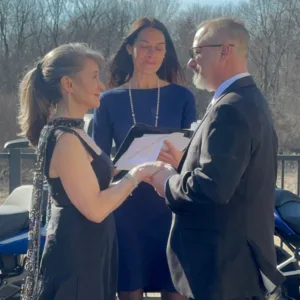 Image: Denise officiating a couple's wedding outdoors