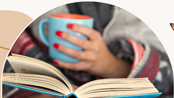 Image: Woman reading a book and holding a cup of coffee