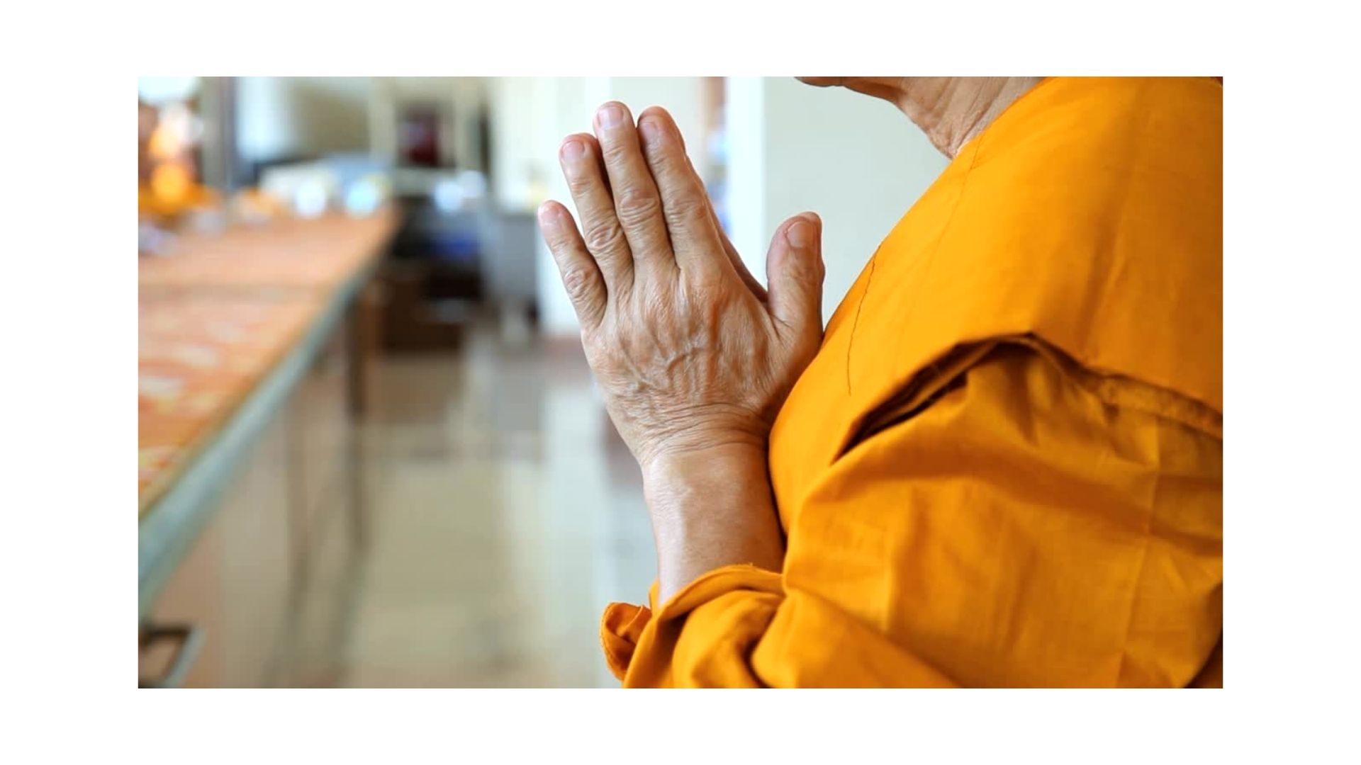 Praying monk at a table