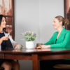 Image: Denise and female client sitting and talking at a table