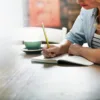 woman journaling at her kitchen table