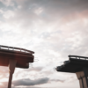 Image: A broken bridge with dark skies, signifying healing the divide