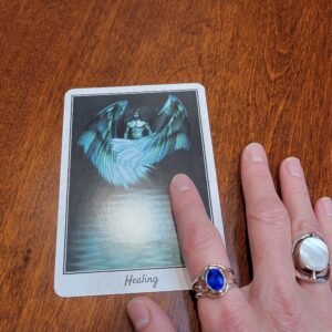 Image: Healing oracle card and hand with the card