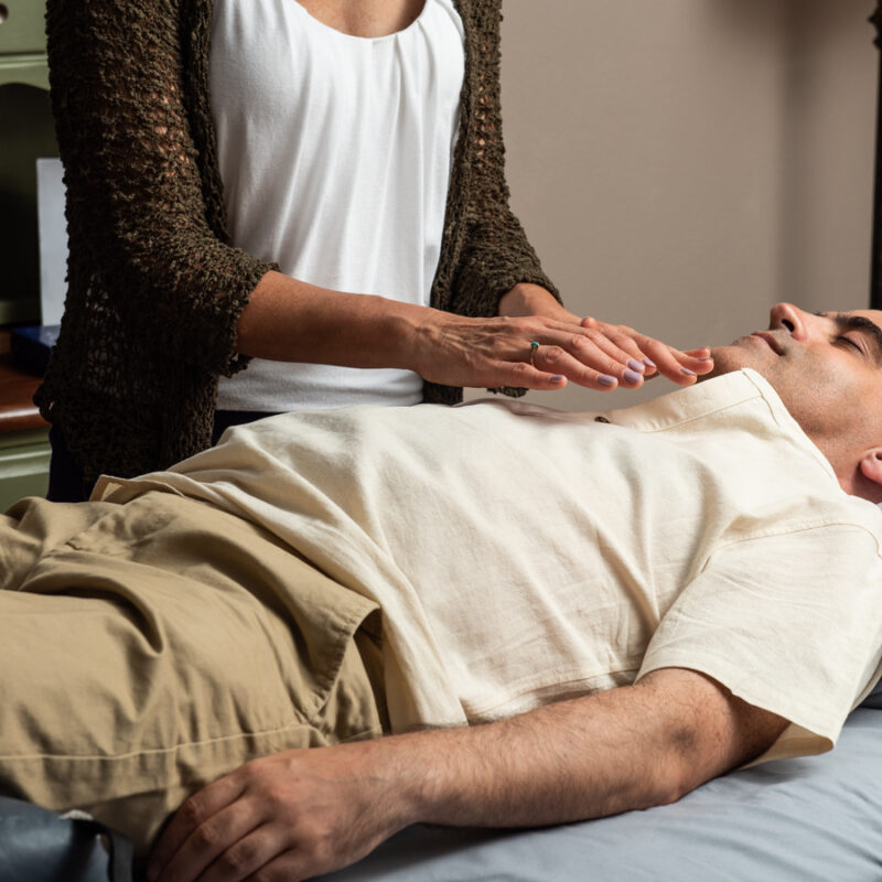 Denise offering Reiki to a client